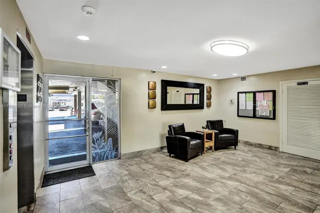 a living room with furniture a piano and a flat screen tv