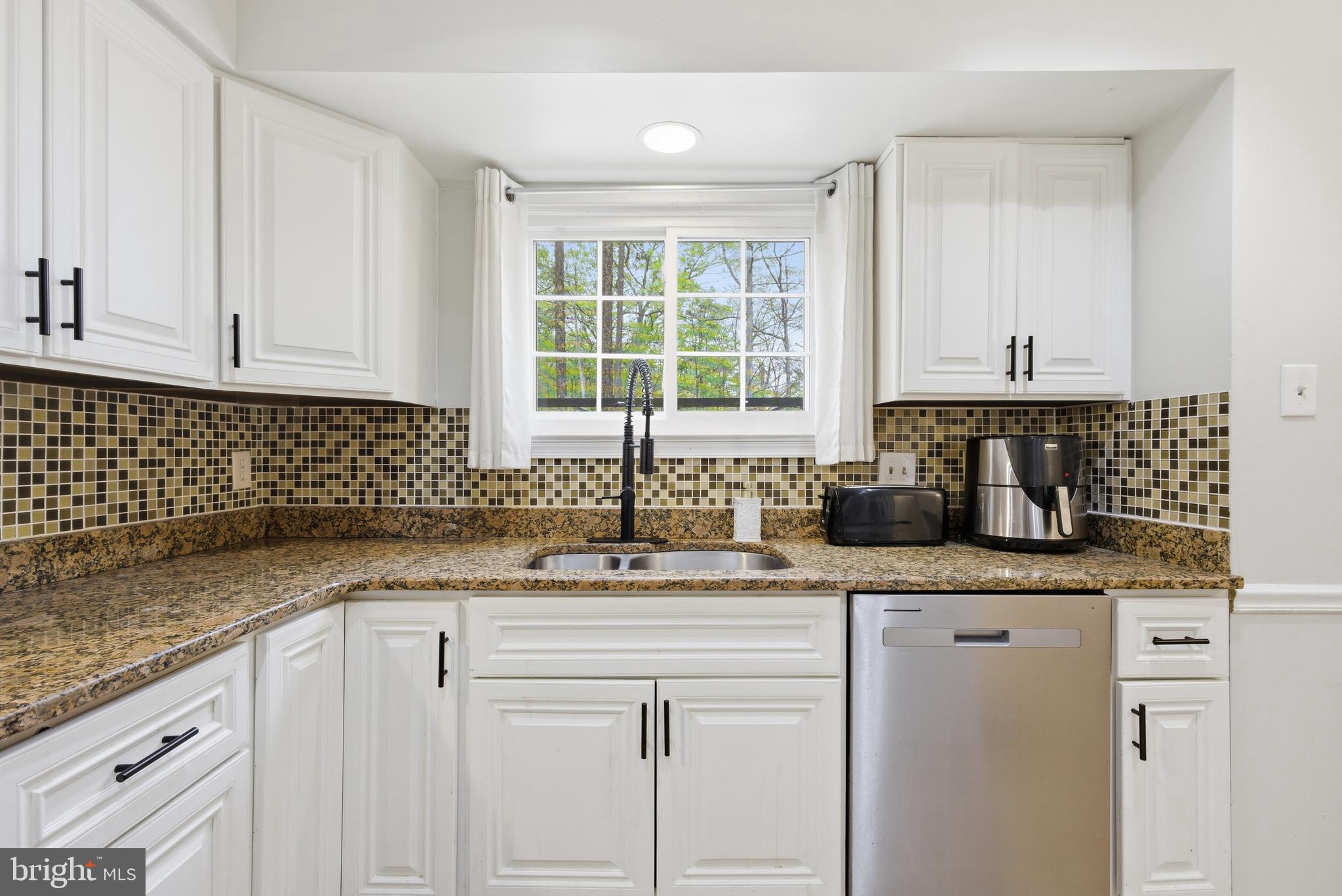 8664 Pohick Forest Court Springfield, VA 22153 - Photo 10 of 41 a kitchen with granite countertop a sink stove and cabinets