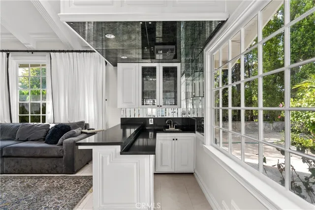 a kitchen with granite countertop a sink and a granite counter tops and a large window