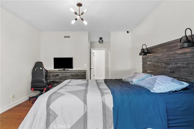 a bedroom with a bed and a flat screen tv