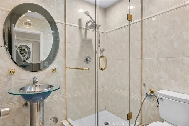 a bathroom with a sink a toilet and a mirror