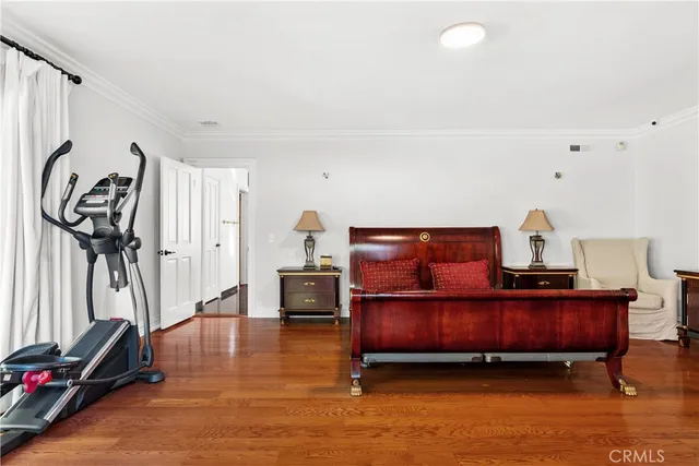 a bedroom with furniture and a wooden floor