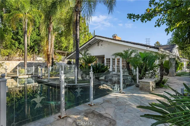 a view of a house with a yard and sitting area