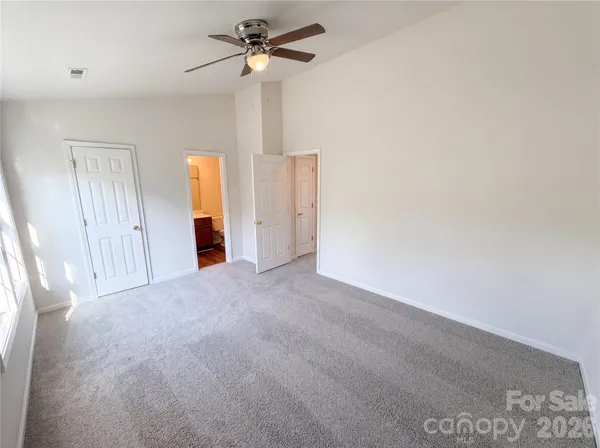 a view of a livingroom with a ceiling fan and window