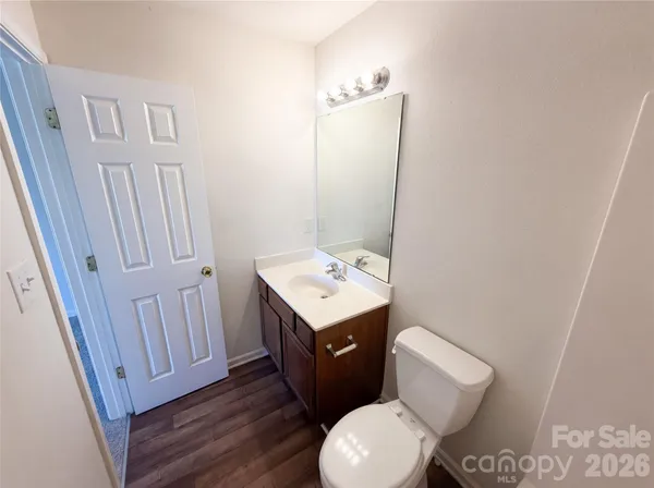 a bathroom with a toilet a sink and a mirror