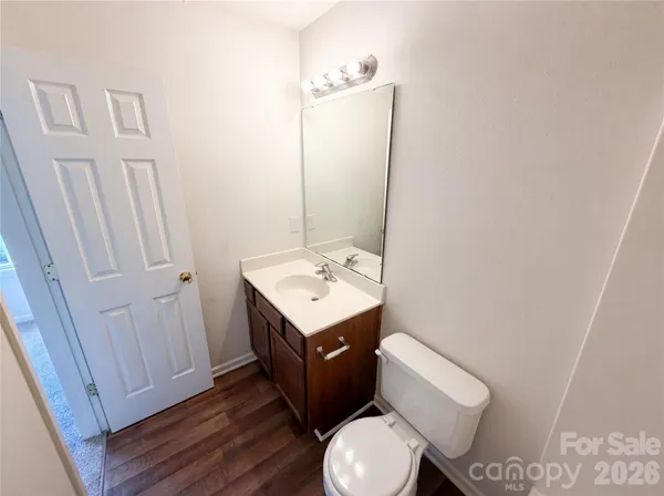 a bathroom with a toilet a sink and a mirror