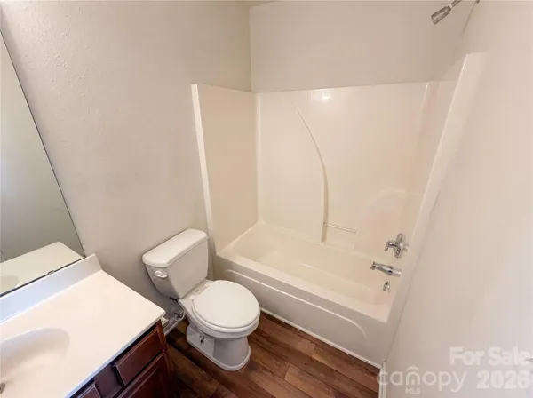 a bathroom with a toilet a sink and bathtub