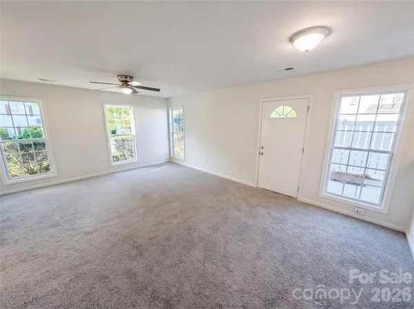 an empty room with windows and closet