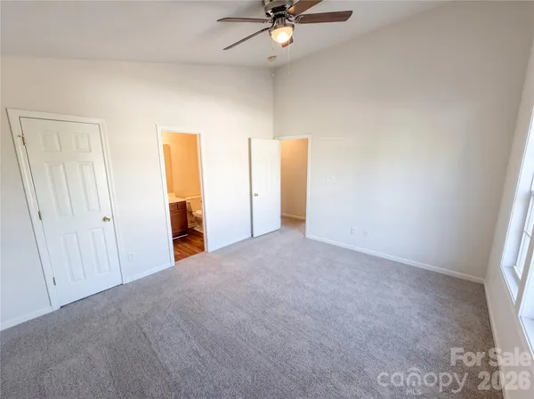 a view of a livingroom with a ceiling fan and window