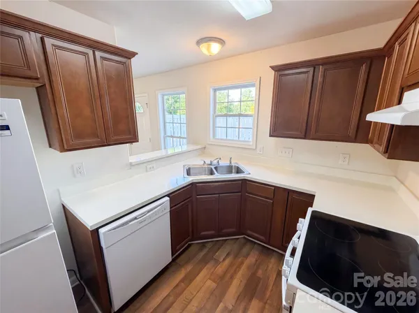 a kitchen with stainless steel appliances a stove a sink and a microwave
