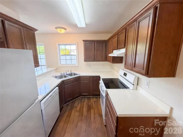 a kitchen with a stove a refrigerator and a microwave