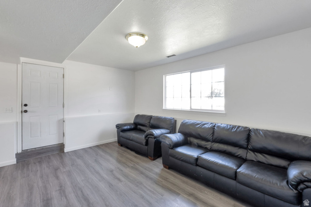 2013 West 460 South Provo, UT 84601 - Photo 18 of 24 Spacious room featuring wood-finish flooring, white walls, and a large window