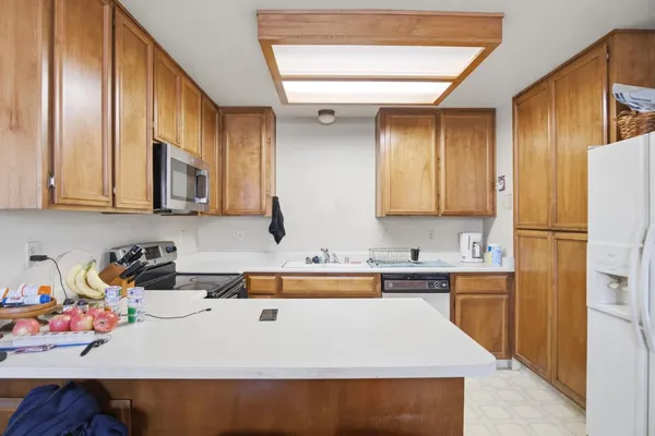 a kitchen with stainless steel appliances a refrigerator a sink and a stove