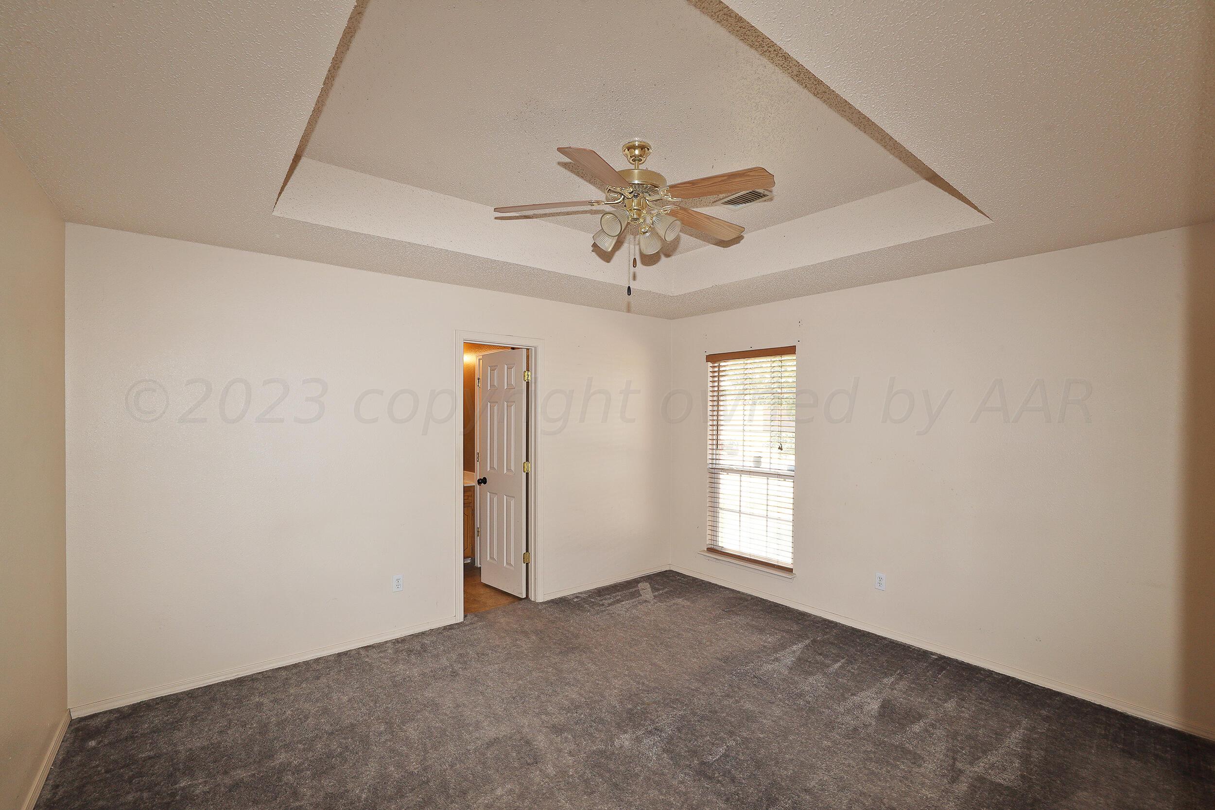 1025 Ketler Street Amarillo, TX 79104 - Photo 13 of 29 an empty room with windows and fan