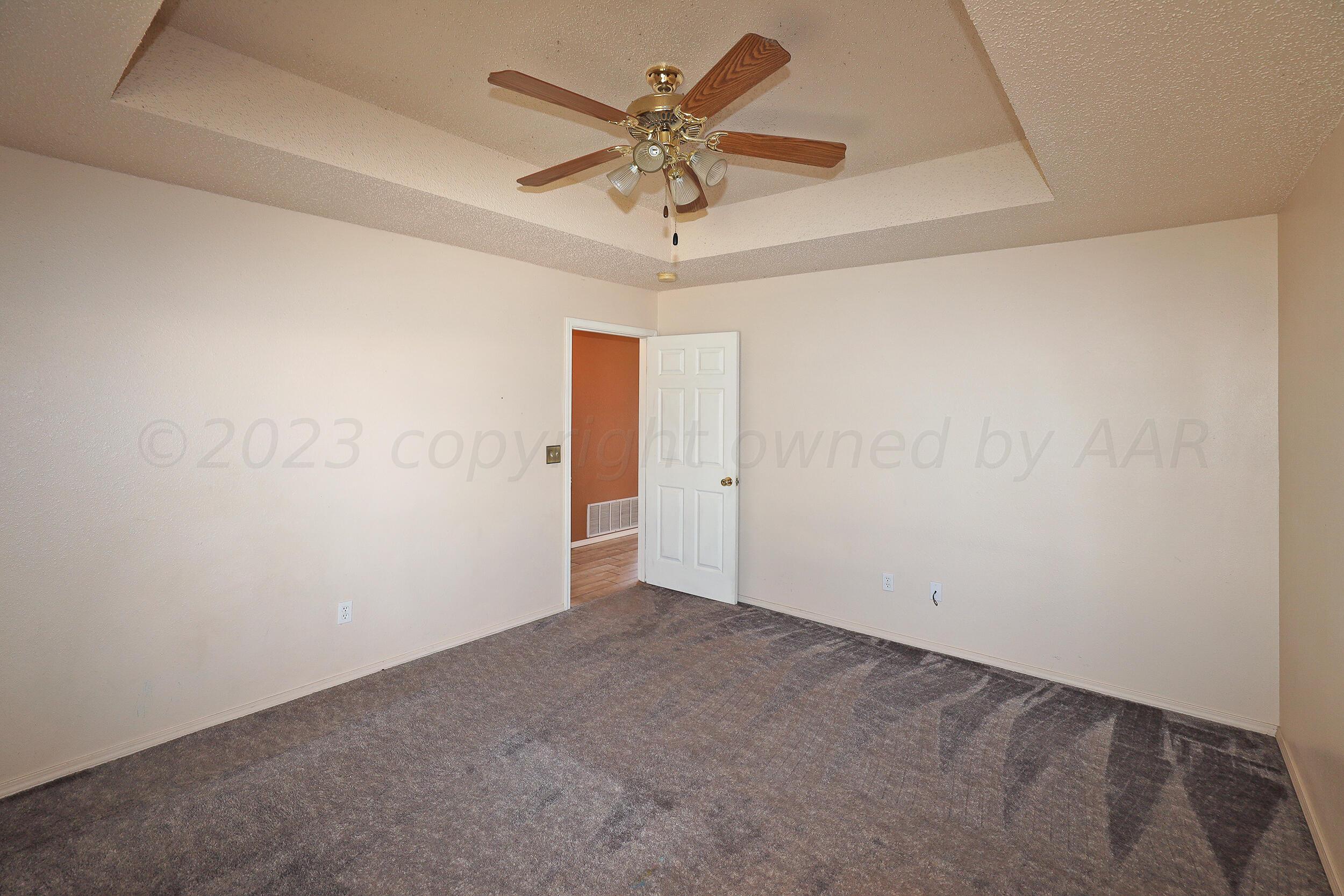 1025 Ketler Street Amarillo, TX 79104 - Photo 14 of 29 an empty room with a ceiling fan and wooden floor