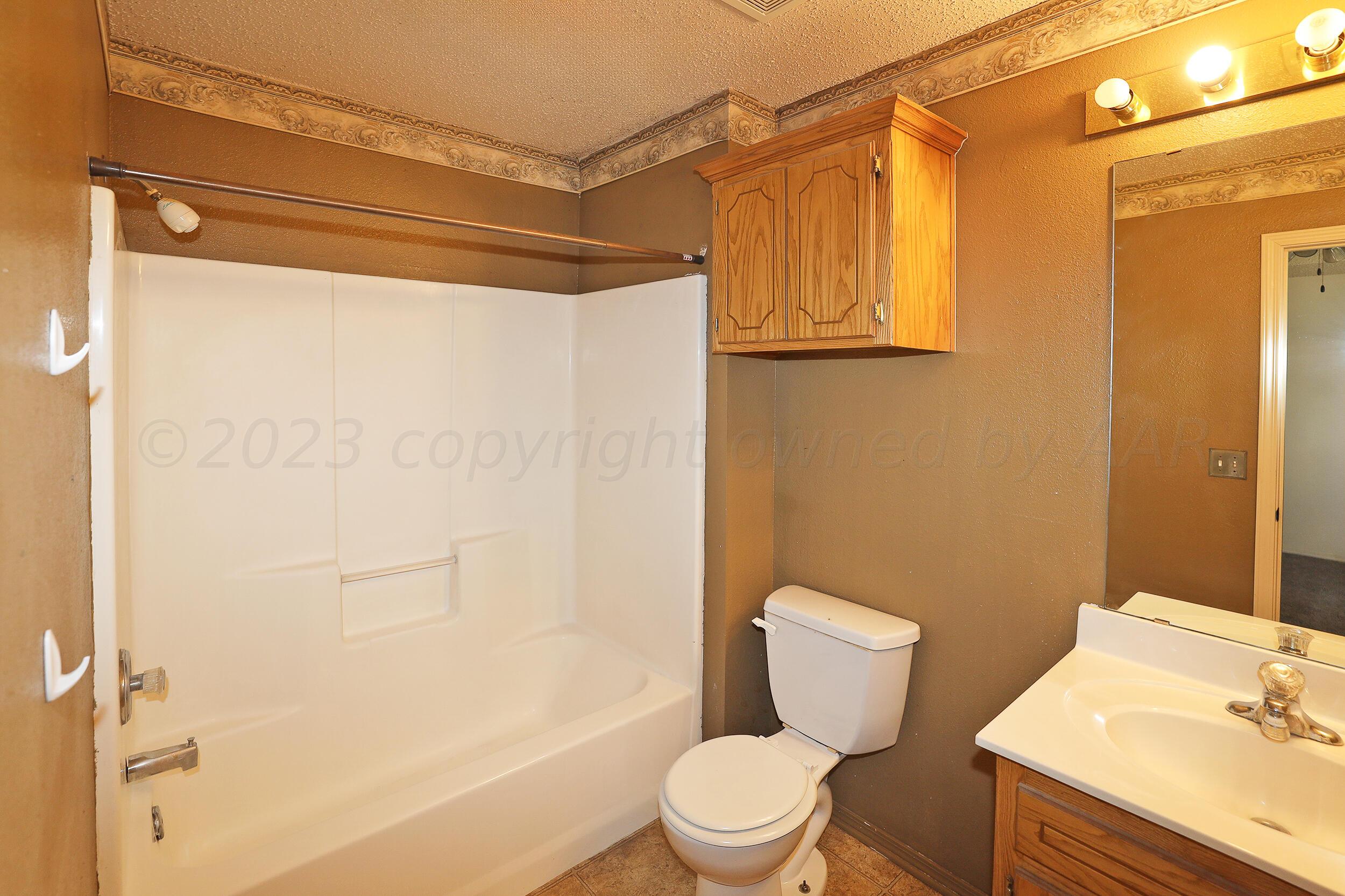 1025 Ketler Street Amarillo, TX 79104 - Photo 15 of 29 a bathroom with a toilet a sink and shower