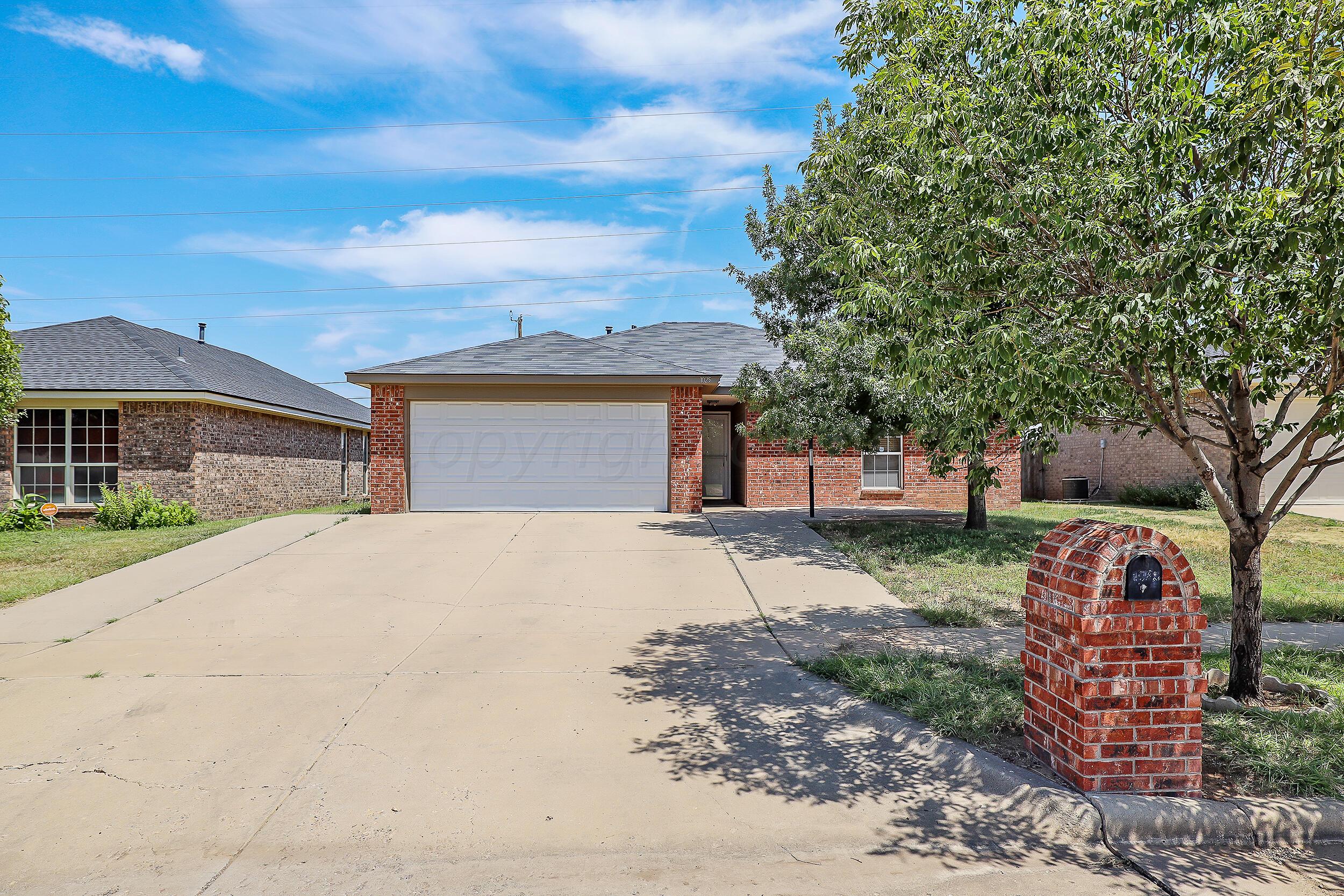 1025 Ketler Street Amarillo, TX 79104 - Photo 2 of 29 a front view of a house with a yard and garage
