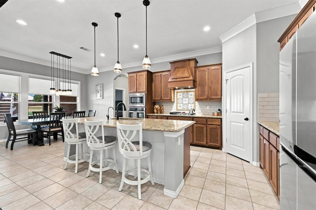 113 High Vista Road Decatur, TX 76234 - Photo 8 of 40 Kirchen made for a Cook and Entertainment! Gas Stovetop with Griddle, Huge Island, Warm Wood Cabinetry, Walk In Pantry.
