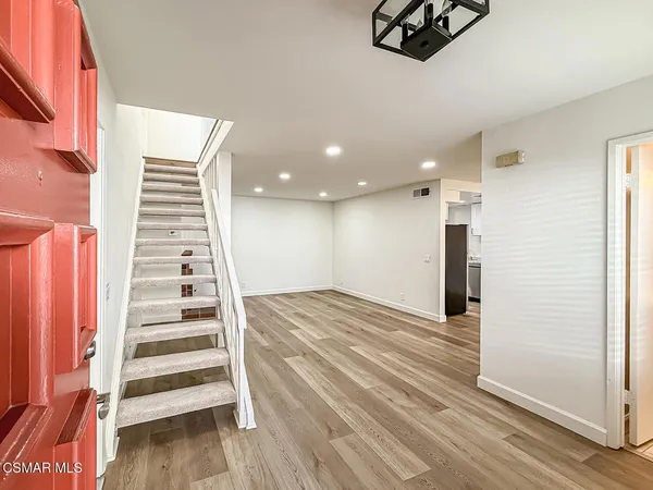 a view of entryway and hall with wooden floor