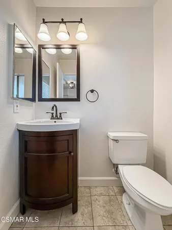 a kitchen with stainless steel appliances granite countertop a stove a kitchen island a dining table and chairs with wooden floor