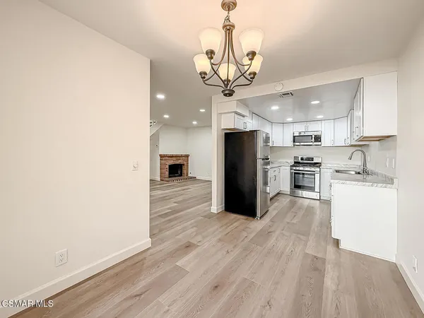 a kitchen with granite countertop a stove and a sink