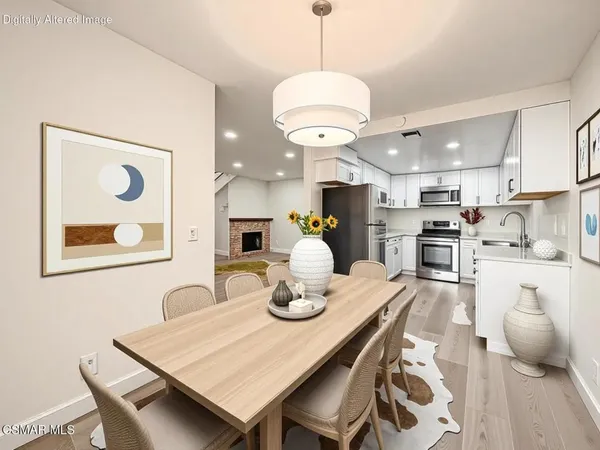 a kitchen with stainless steel appliances granite countertop a stove and a white cabinets