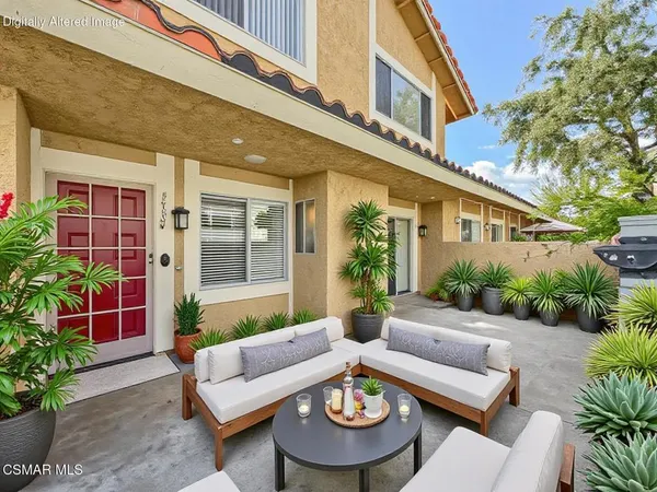 a view of a patio with couches table and chairs and potted plants
