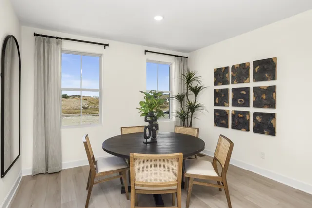 a dining room with furniture and window