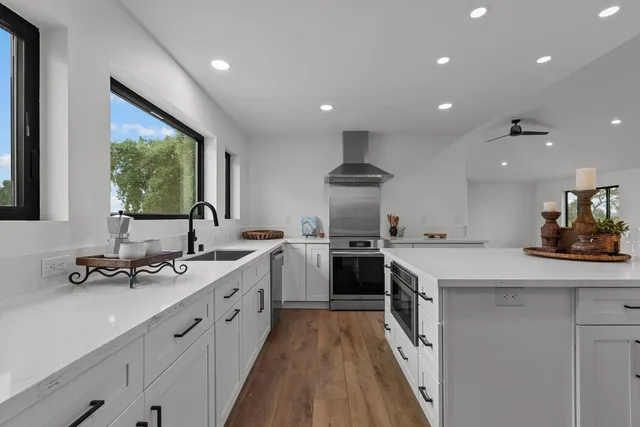 a kitchen with a sink stove and refrigerator