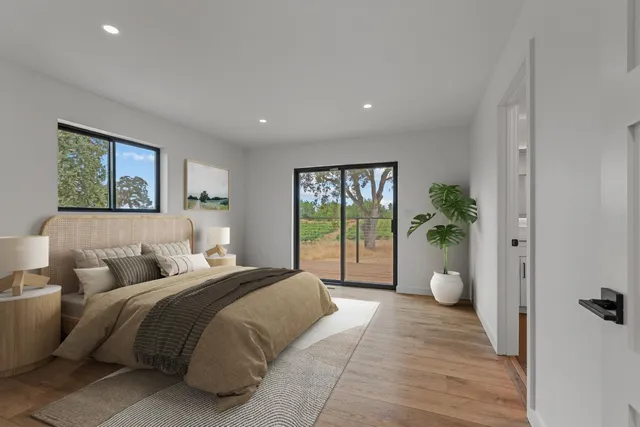 a bedroom with a large bed and windows