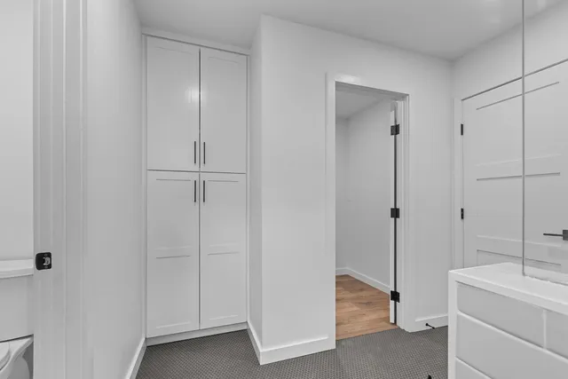 a bedroom with a large bed and a painting on the wall