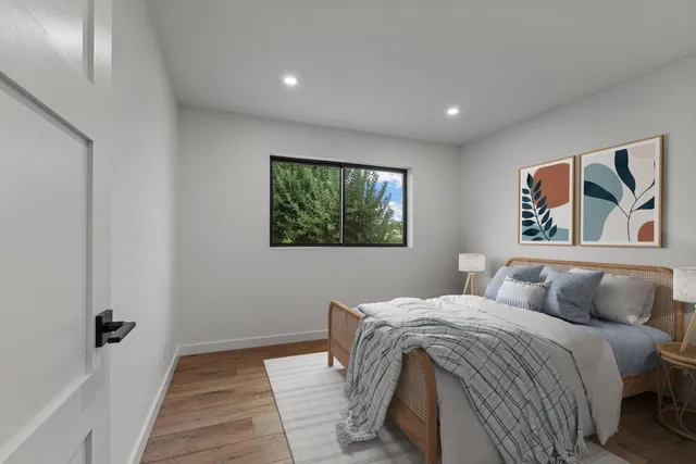 a bedroom with furniture and a potted plant