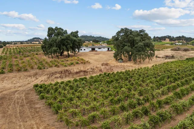 an aerial view of a house with a lake view