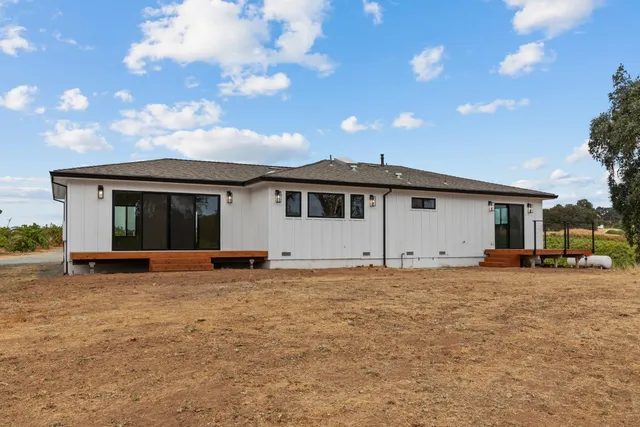 a terrace of a house with wooden floor and outdoor seating