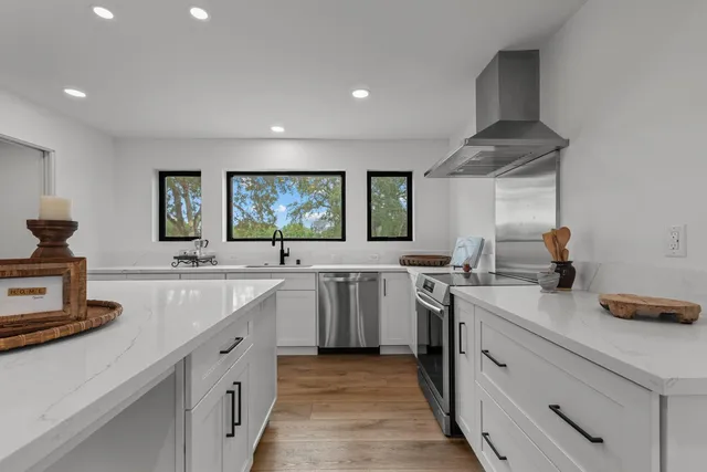 a kitchen with a sink stove and cabinets