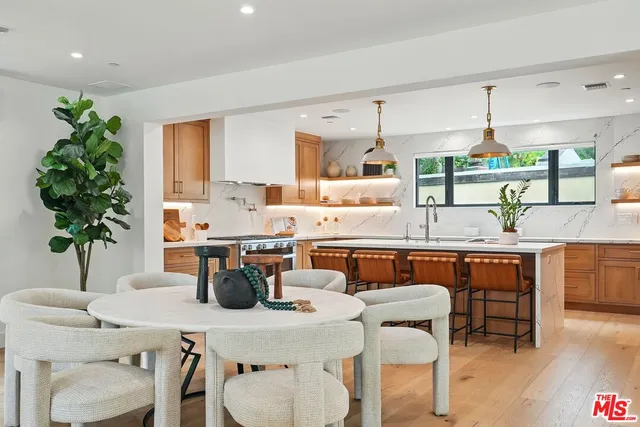 a kitchen with a table and chairs in it