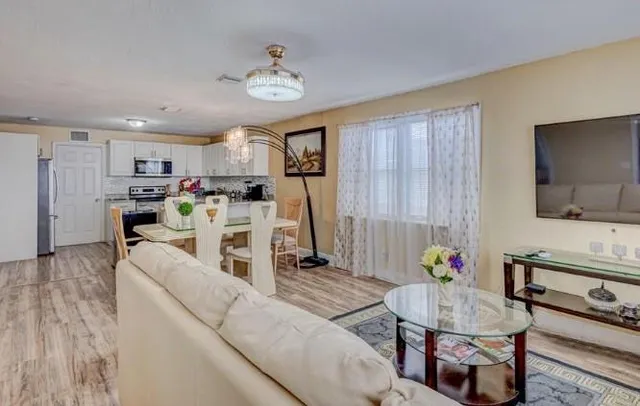 a living room with furniture and kitchen view