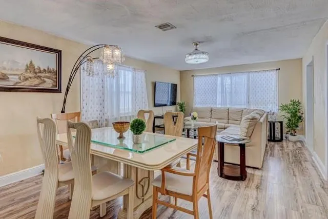 a view of a dining room with furniture and wooden floor