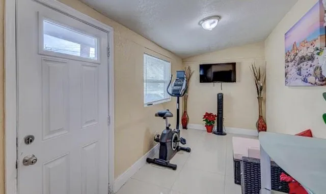 a room with gym equipment and a window