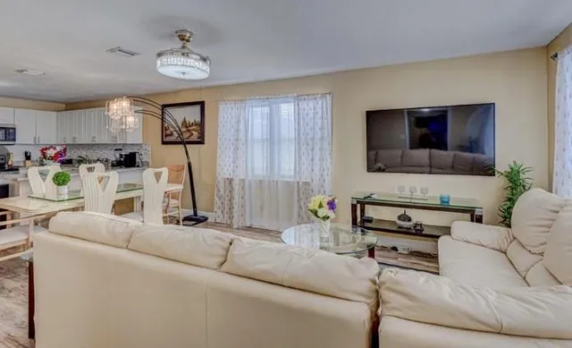 a living room with furniture and a flat screen tv