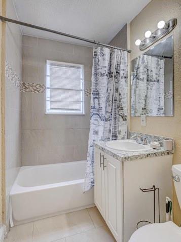 1105 West 34th Street Riviera Beach, FL 33404 - Photo 8 of 15 a bathroom with a granite countertop sink a toilet a mirror a bathtub and shower