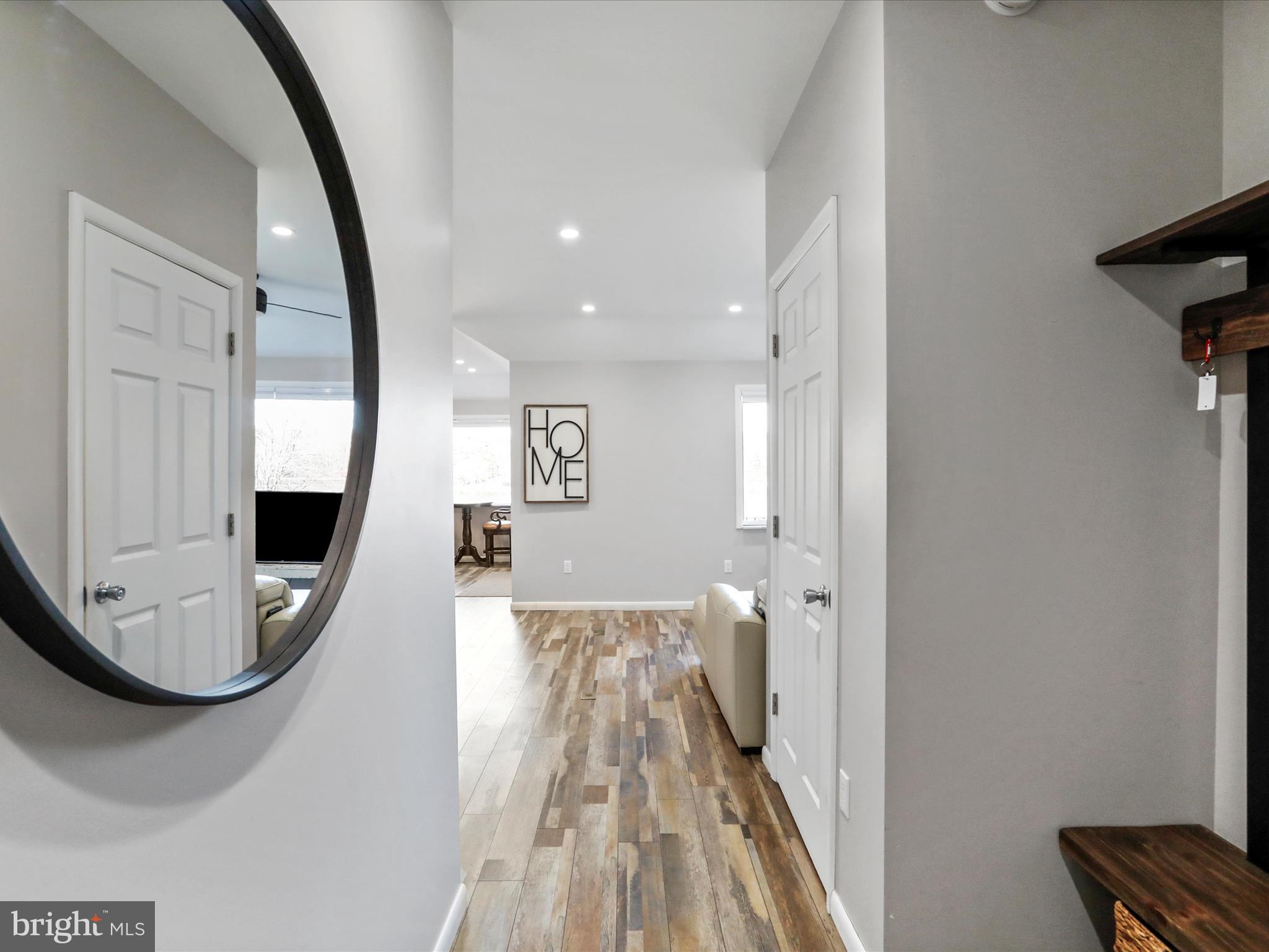 468 Pritts Road Swanton, MD 21561 - Photo 13 of 58 a view of a livingroom with wooden floor and a mirror