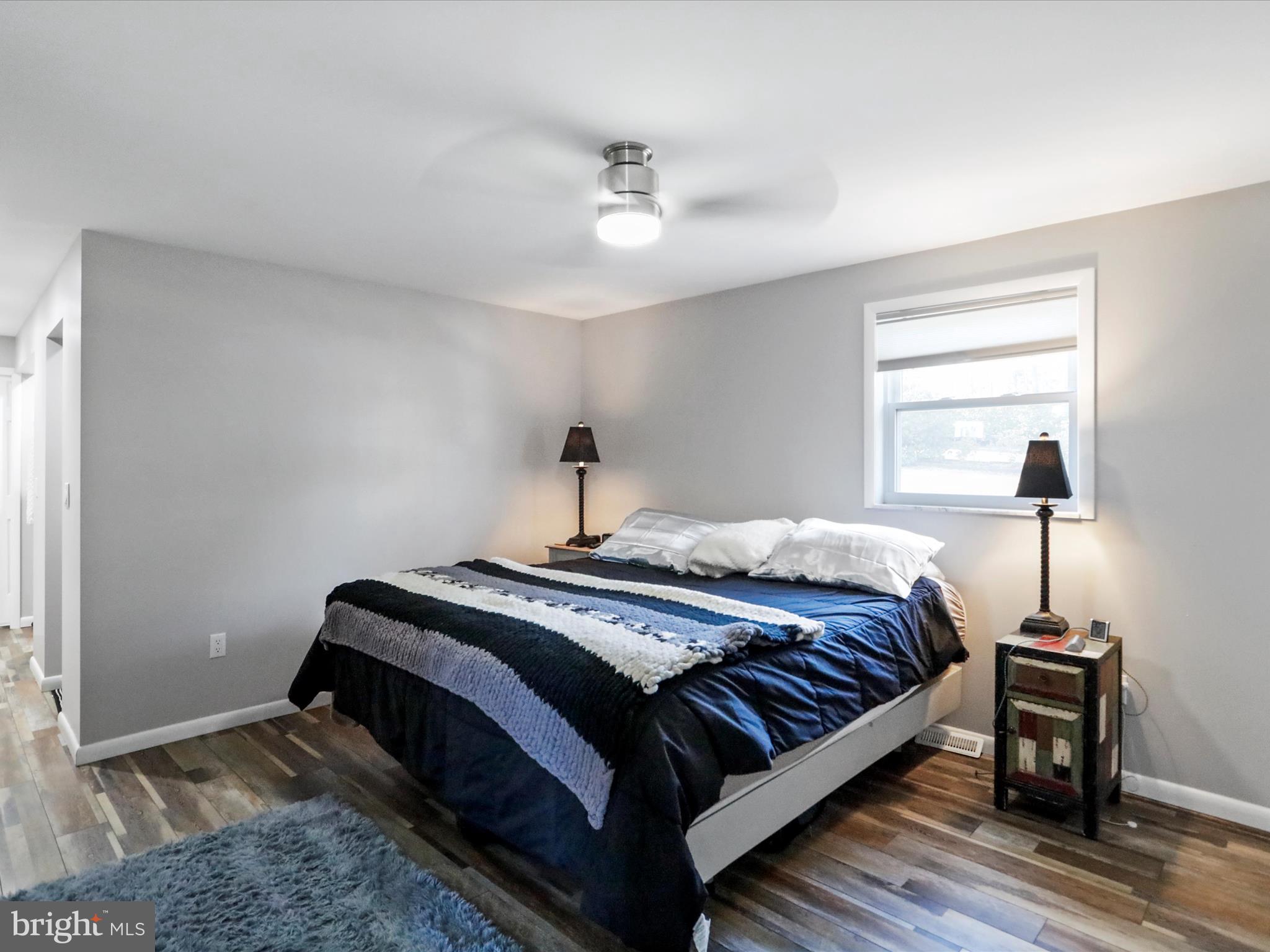 468 Pritts Road Swanton, MD 21561 - Photo 15 of 58 a bedroom with a bed and wooden floor