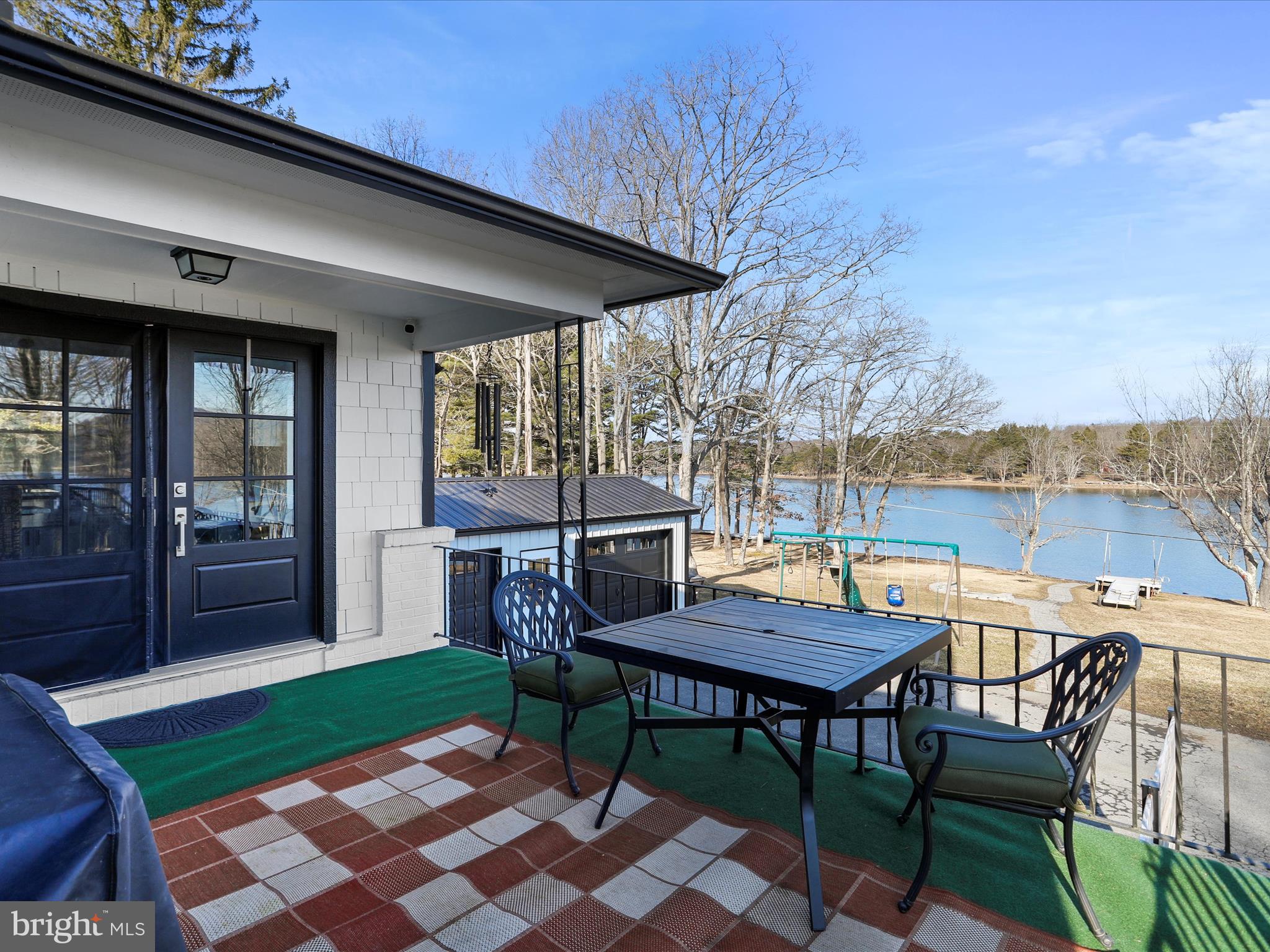 468 Pritts Road Swanton, MD 21561 - Photo 39 of 58 a view of a patio with a dining table and chairs with wooden floor
