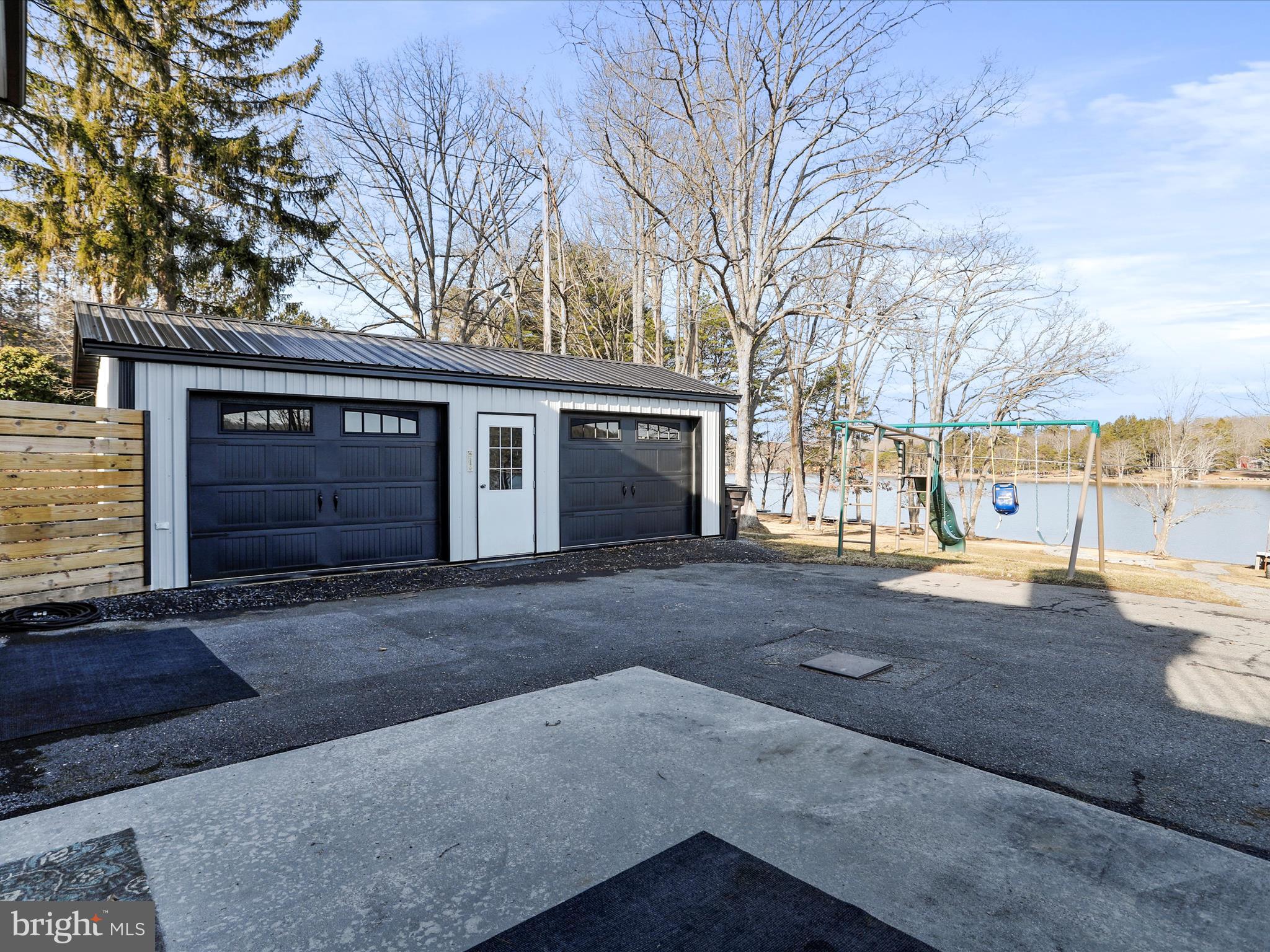 468 Pritts Road Swanton, MD 21561 - Photo 43 of 58 a front view of a house with a yard and garage