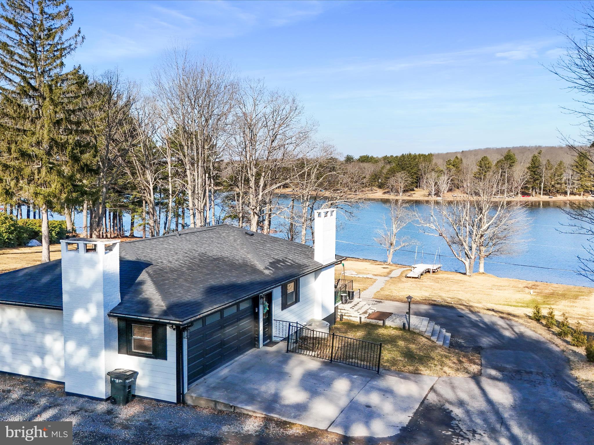 468 Pritts Road Swanton, MD 21561 - Photo 47 of 58 a view of a patio with lawn chairs under an umbrella