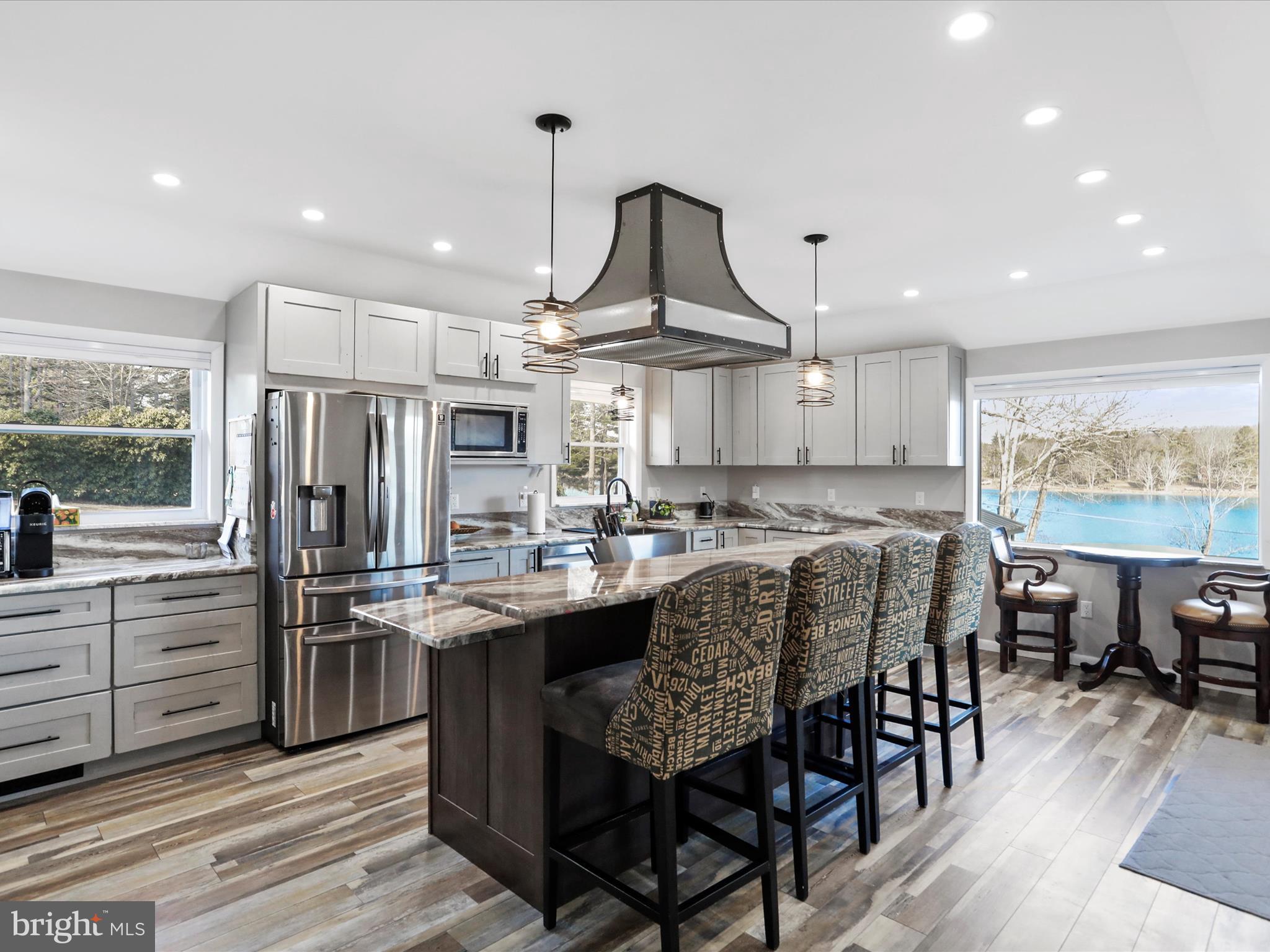 468 Pritts Road Swanton, MD 21561 - Photo 5 of 58 a kitchen with stainless steel appliances a dining table chairs stove and refrigerator