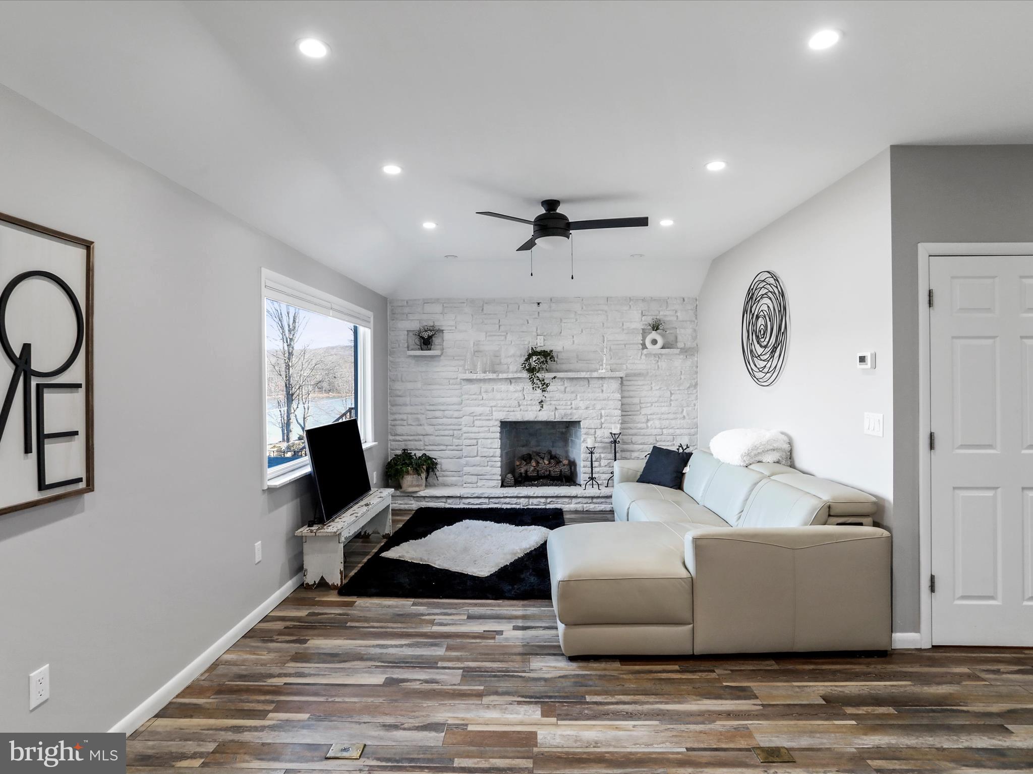 468 Pritts Road Swanton, MD 21561 - Photo 10 of 58 a living room with fireplace furniture and a wooden floor