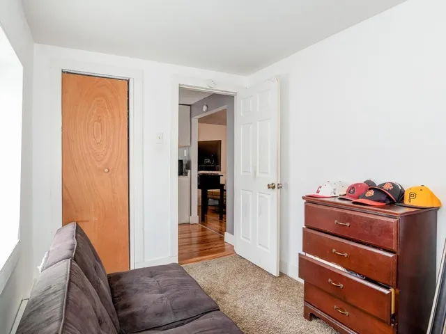 a living room with furniture and a closet