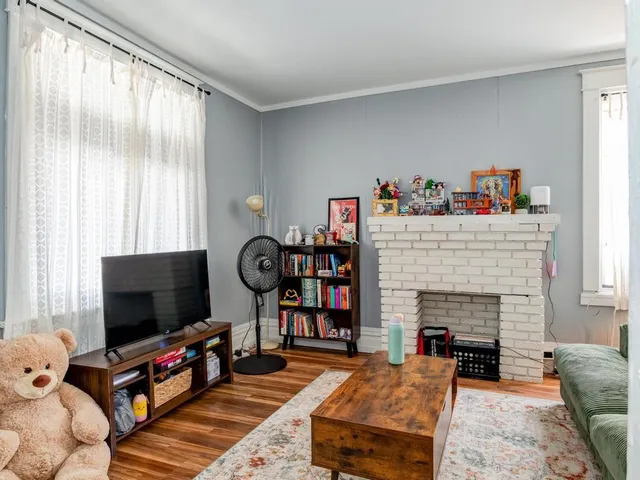 a living room with fireplace furniture and a flat screen tv